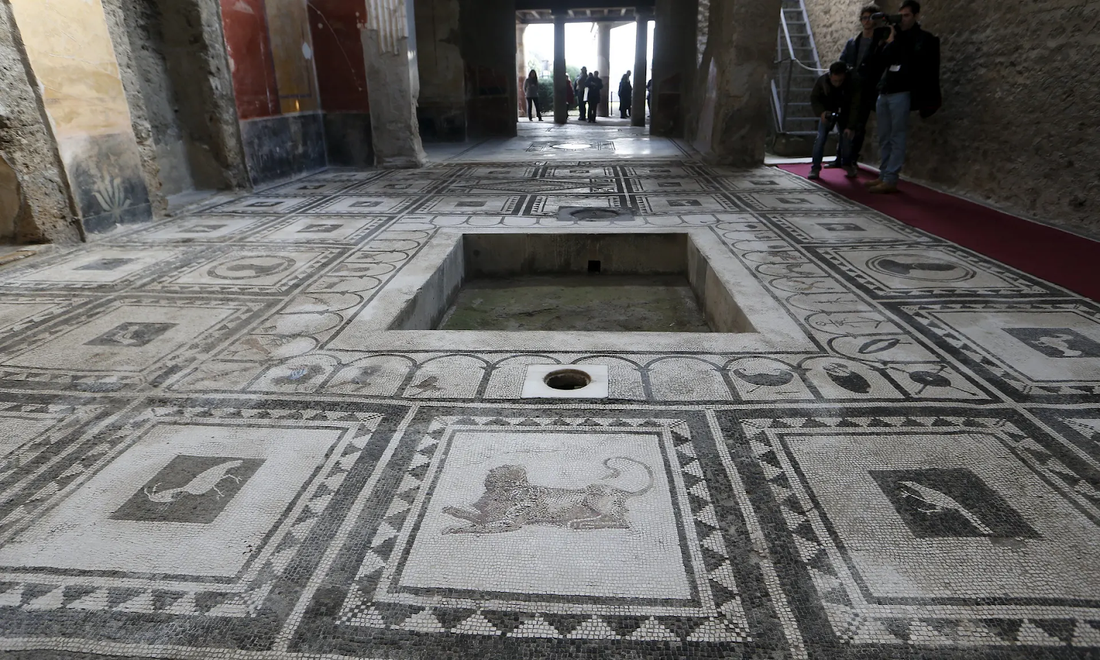 Ancient Roman floor mosaic around a sunken basin, its border set with small animal panels
