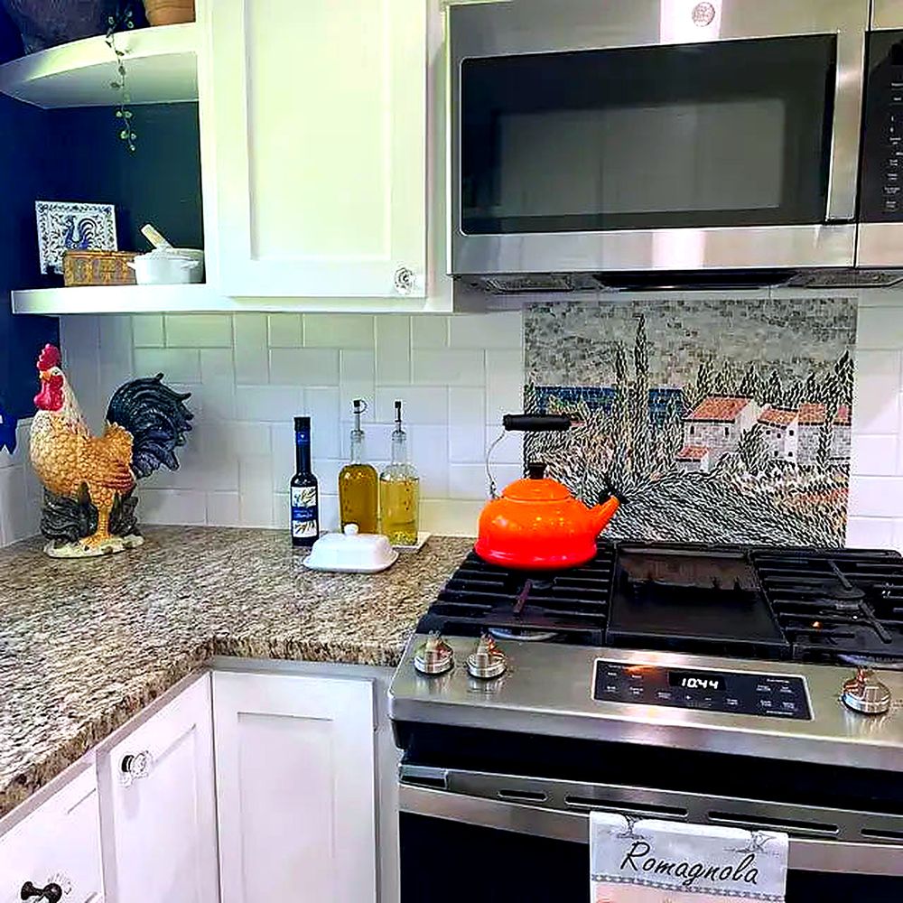 Luxurious kitchen adorned with an intricate, flowing mosaic art backsplash, highlighting refined design and craftsmanship.