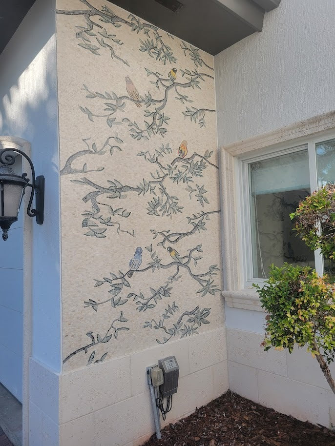 a bird mosaic installed as patio decor 