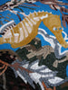 Cavalo marinho dourado sobre mosaico azul na parede
